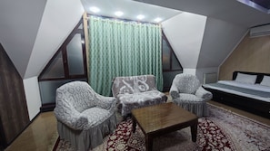 Deluxe Double Room | Living area | 48-inch LED TV with cable channels, TV