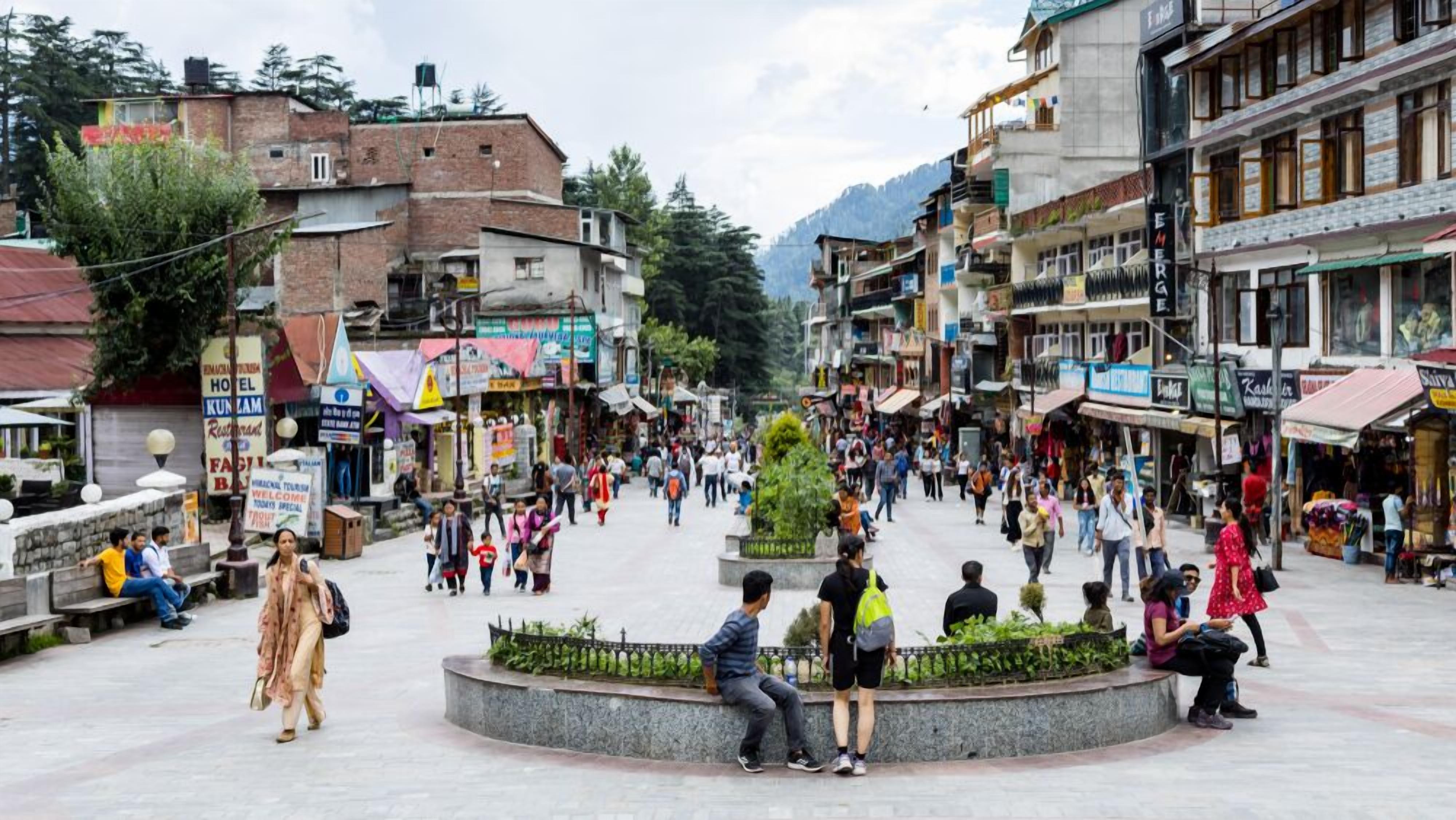 A busy public square with shops and buildings around.