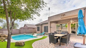 A backyard with a swimming pool, patio furniture, and a covered outdoor seating area. - Private Pool & Community Perks: Mesa Home! (Mesa)