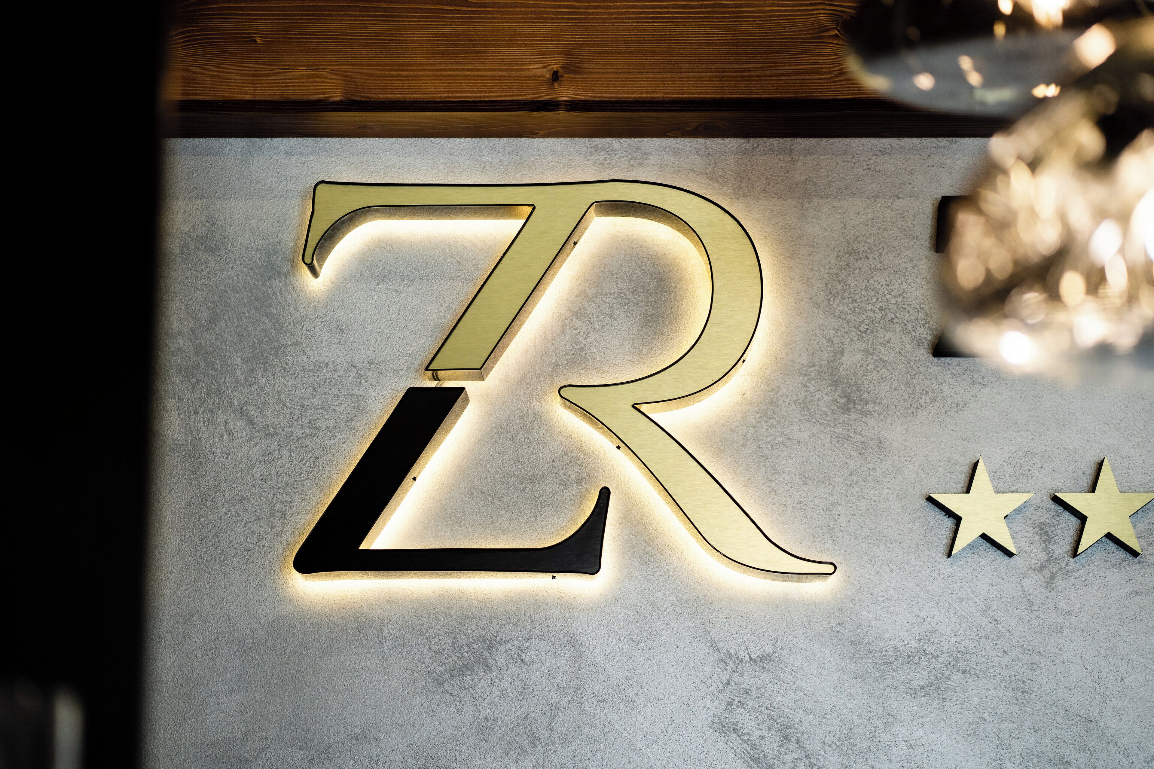 A large illuminated 'Z' sign on a textured wall.