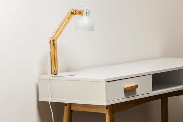 A white desk with a wooden frame, a drawer, and a wooden desk lamp with a white shade. - Clifton Spacious 3 Bed Apt&Parking-Simply Check In (Bristol)