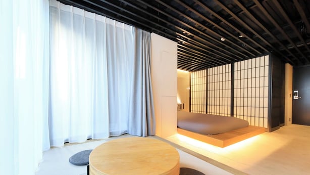 A traditional Japanese room with tatami flooring, a low wooden table, and a sliding shoji screen. - AMANECER HOTEL (Tokyo)