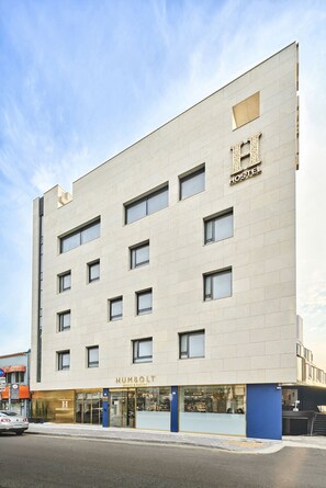 A modern building with a sign for 'HUMBOLT Coffee & Bakery' on the ground floor.