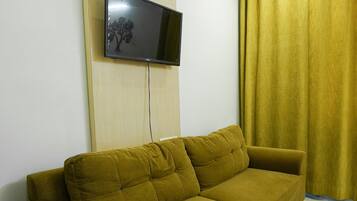 Standard Apartment | Living area | 30-inch Smart TV with cable channels