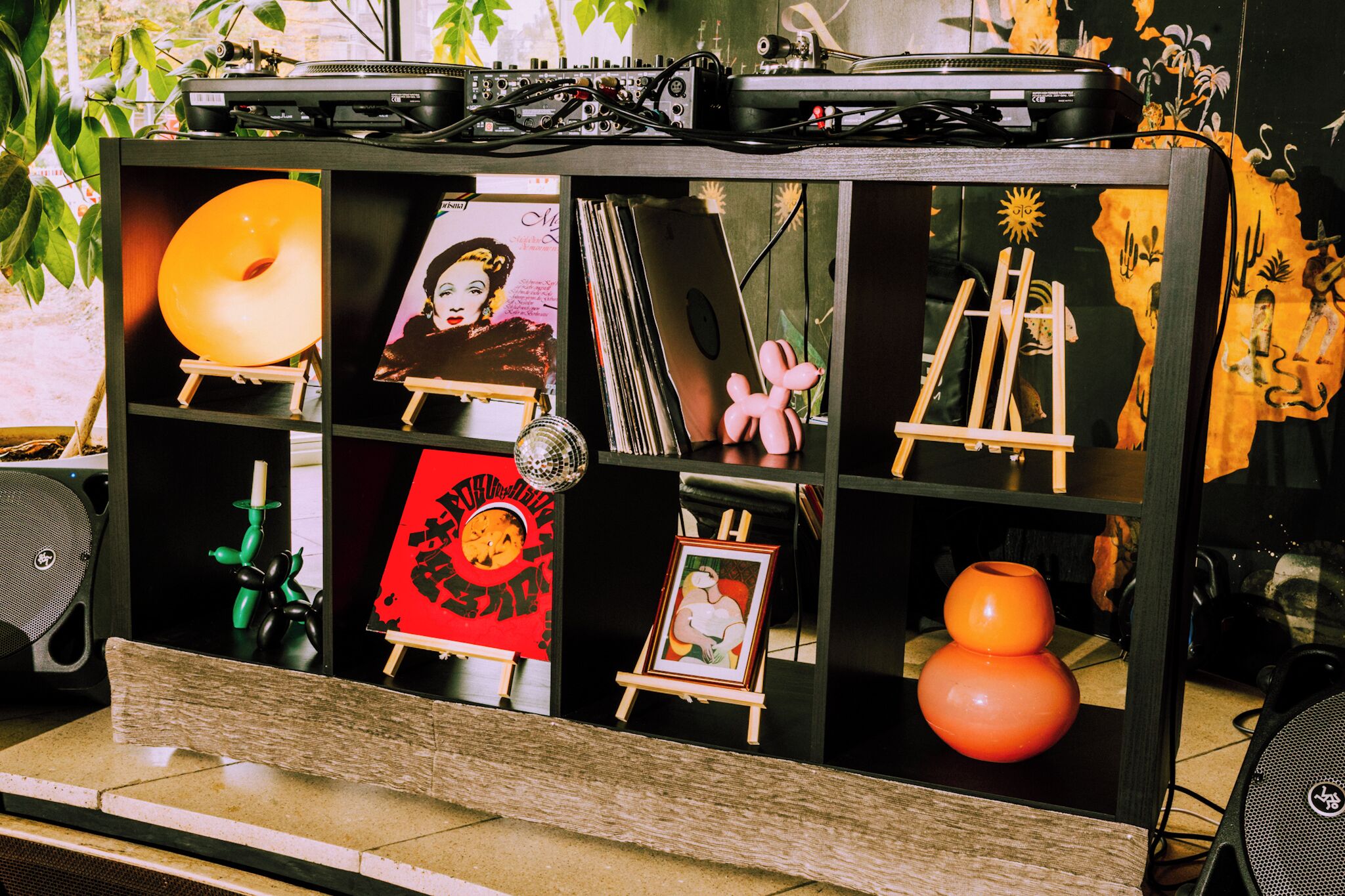 A display cabinet with various artworks and decorative items.