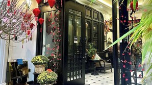A traditional Chinese-style entrance with red lanterns, floral decorations, and a black gate. - Camellia Residence Hanoi (Hanoi)