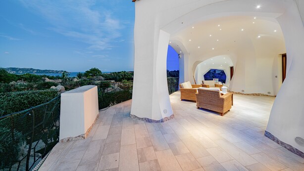 A modern outdoor living area with a view of the sea, featuring a seating area with a sofa and a coffee table. - Villa Adele, sea view, pool, 700 meters from the beach (MONTE PETROSU)