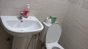 Een douche, handdoeken, zeep, shampoo