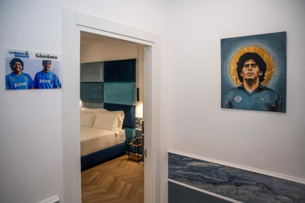 Ein Schlafzimmer mit einem Bett, einem Nachttisch und einem Wandbild.