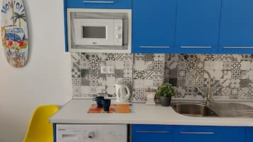 Appartamento Classic | Angolo cottura privato | Frigorifero con congelatore, microonde, piano cottura