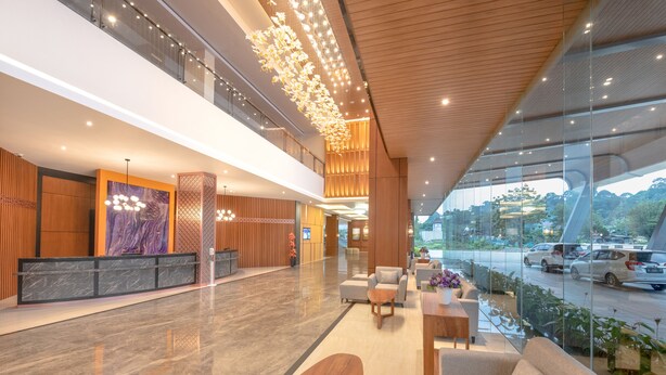 A spacious lobby with a reception desk, seating area, and large windows overlooking a road. - FOX Harris Hotel & Conventions Banjarnegara (Banjarnegara)