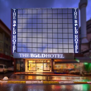 A hotel facade with a large sign reading "The Bold Hotel" and a grid-like window pattern. - The Bold Hotel (Istanbul)