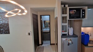 A modern kitchen with a microwave, a refrigerator, and a sink.