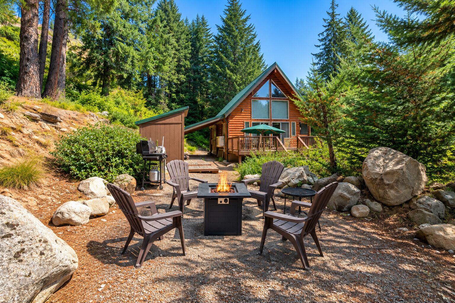 A cabin with a deck, outdoor seating, and a fire pit.