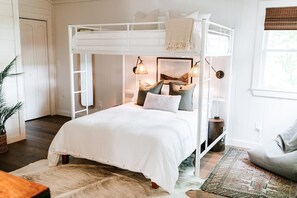 A bunk bed room with a white canopy, a framed picture on the wall, and a small table with a plant. - Luxe 4BR Designer Cabin  Hot Tub • Views • Fire (Cherry Log)