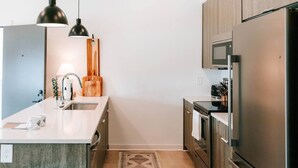 A modern kitchen with a central island, stainless steel appliances, and a minimalist design.