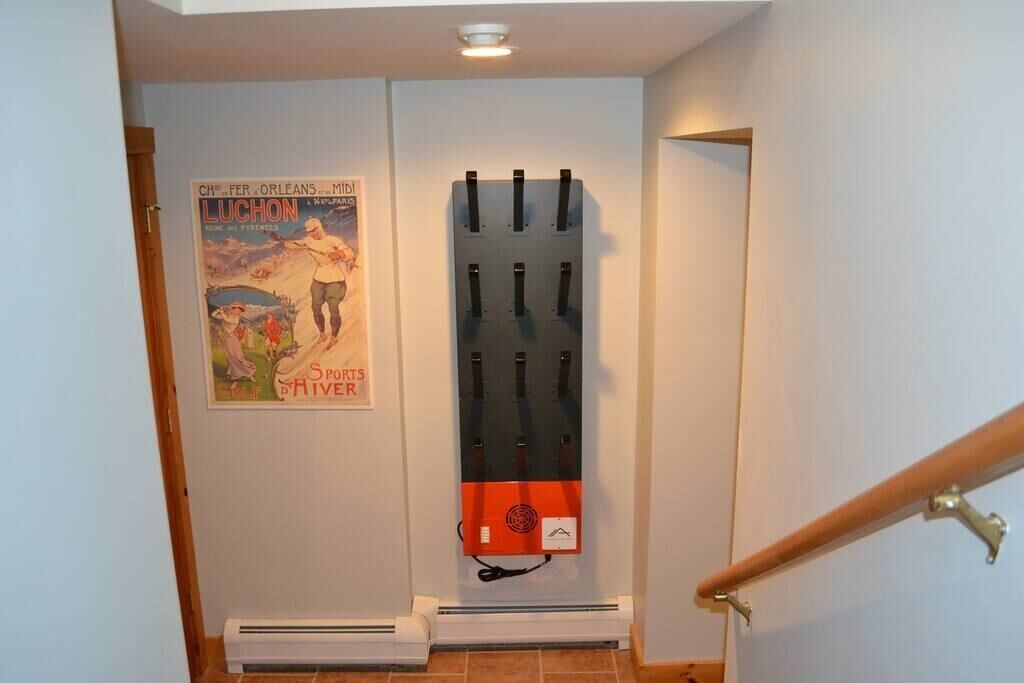 A staircase with a wall-mounted rack holding several items.
