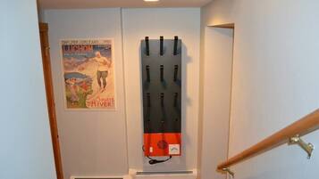 A staircase with a wall-mounted rack holding several items.