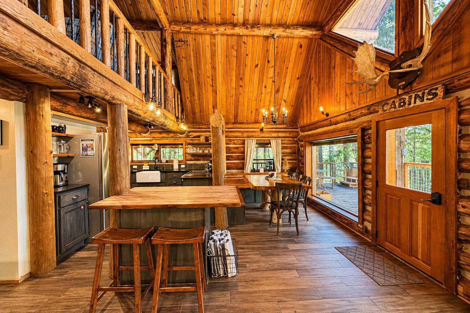 A log cabin interior with a kitchen, dining area, and a sign indicating 'CABINS'.