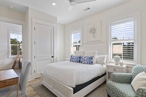 A bedroom with a large bed, a desk, a chair, and a window with blinds. - Blue Mountain Escape with Private Pool, Bikes, and Walkable Beach Access (Santa Rosa Beach)