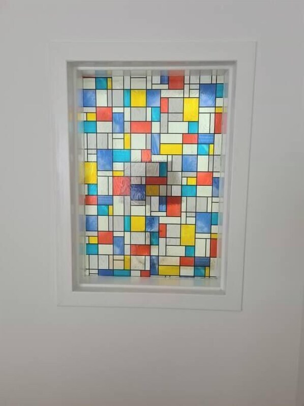 A square window with a colorful geometric pattern.