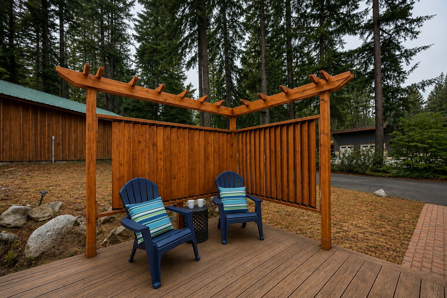 A wooden pergola with two Adirondack chairs, a small table, and a metal trash can.