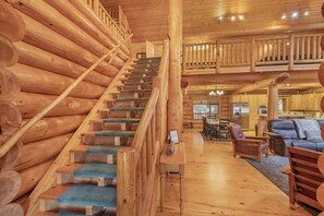 A wooden staircase with blue carpet leading to a second-floor balcony. - Soaring Pines Lodge 1 Bedroom Home by NW Comfy Cabins by RedAwning (Leavenworth)