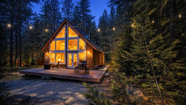 A cabin with a large deck, surrounded by trees. - Cascades Adventure Cabin 2 Bedroom Home by NW Comfy Cabins by RedAwning (Leavenworth)
