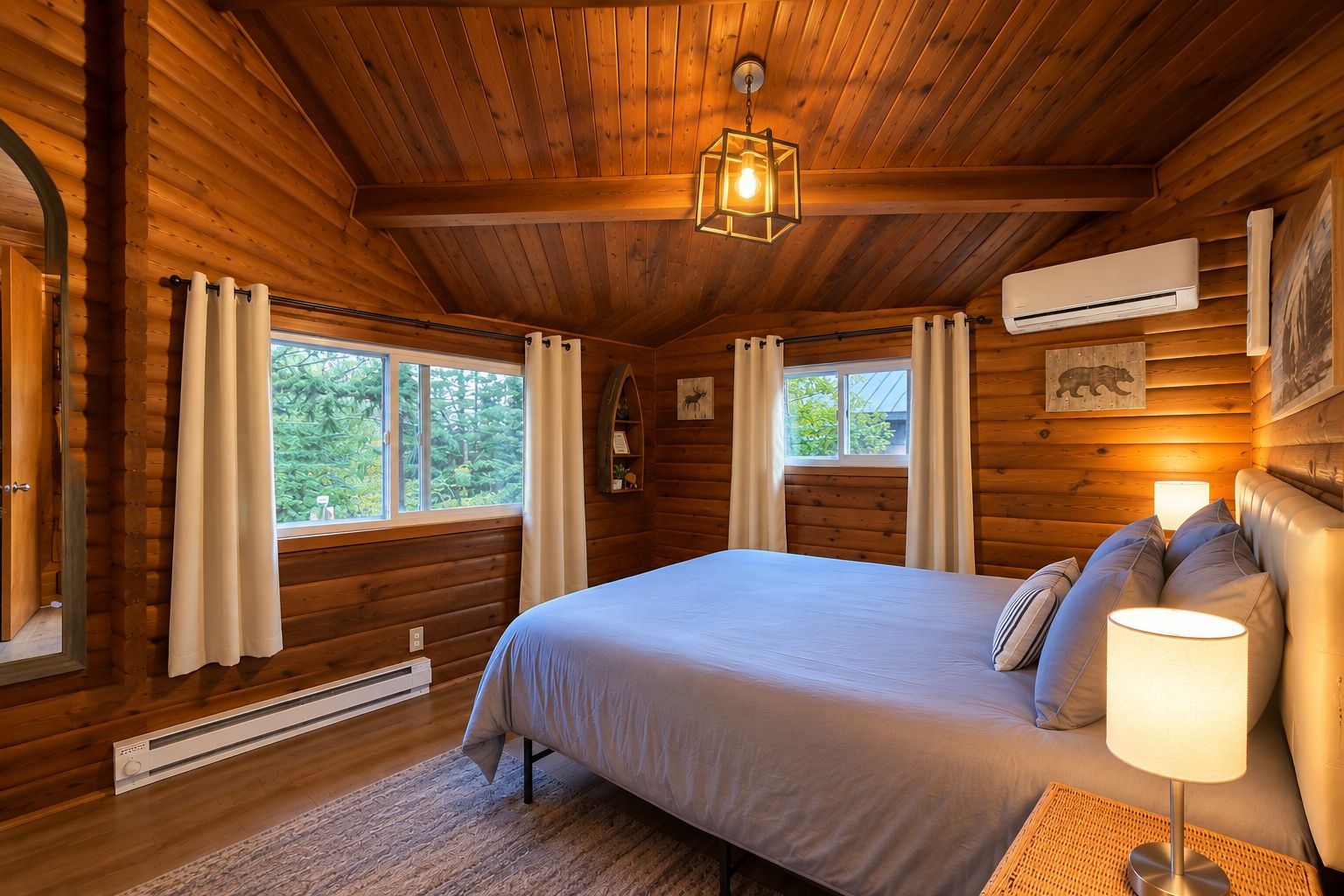A log cabin bedroom with a bed, curtains, a window, a wall-mounted air conditioner, and a bear picture.