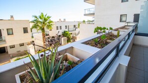 A modern building with balconies, some with plants and others with railings. - 3082 RES LOMAS DE CAMPOAMOR (Orihuela Costa)