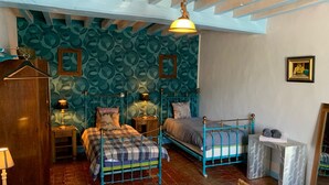 A room with two beds, a wardrobe, a hanging lamp, and patterned wallpaper. - Alfred and George, The Appendix (Sainpuits)