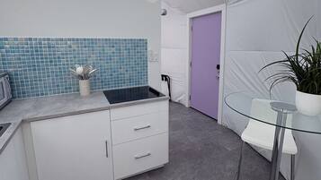 Fridge, microwave, coffee/tea maker, cookware/dishes/utensils