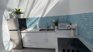 Fridge, microwave, coffee/tea maker, cookware/dishes/utensils