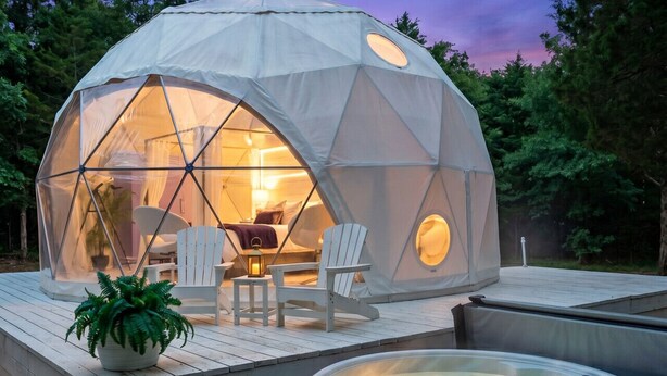 A geodesic dome structure with a hot tub and outdoor seating area. - The Starman Dome (Saint Jo)