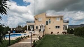 A two-story house with a swimming pool, a well-maintained lawn, and a view of the surrounding landscape. - Luxury, Modern Villas with private pool & garden in Coral Bay area (Πέγεια, Πάφος)