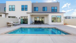 A modern two-story house with a swimming pool, outdoor furniture, and large windows. - Private Pool & Hot Tub • Rooftop Fire Pit • Sleeps 20 • Near Zion (Washington)