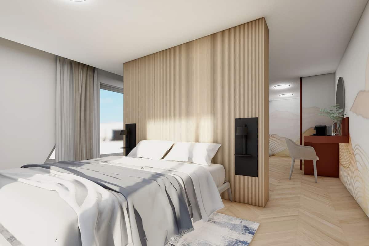 Un dormitorio moderno con cama, mesitas de noche, un escritorio y una silla.