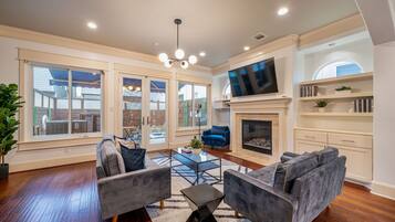 Deluxe House | Living area | 65-inch Smart TV with cable channels, TV, fireplace