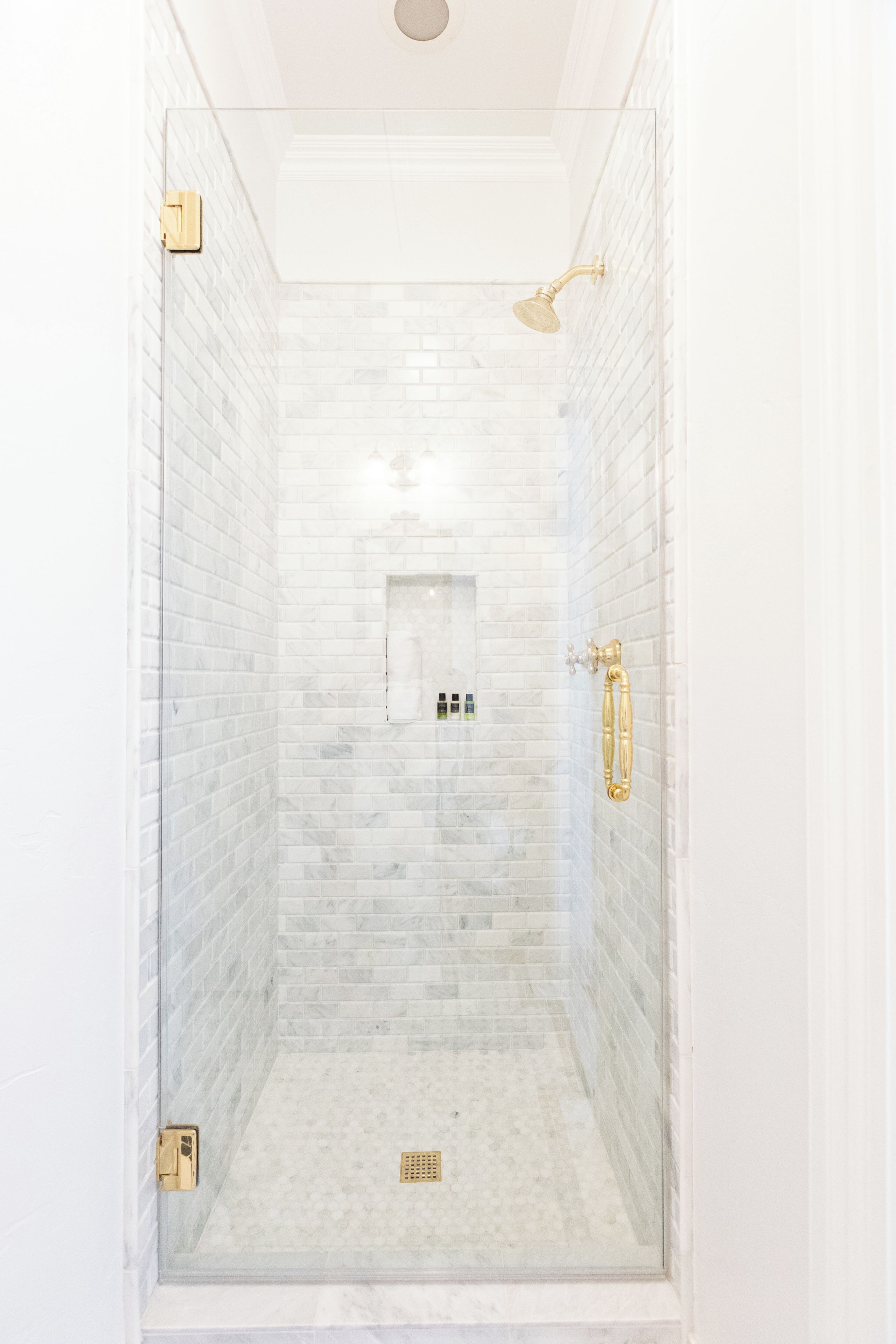 A gorgeous marble shower with brass touches give a feeling of royalty in The Queen On Main's Garden Room bathroom. We had the showerhead "customized" for one of the best showers you will ever experience!