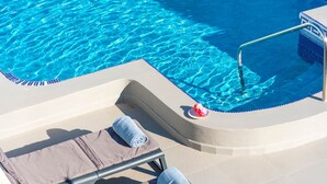 A poolside area with lounge chairs and a pool. - Family villa with private heated pool and ocean views (Tabaiba)
