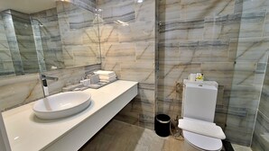 A modern bathroom with a large mirror, a white sink, and a toilet. - HANZ The Moon Hotel 2 (Ho Chi Minh City)