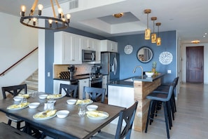 Enjoy cooking and dining in this well-equipped kitchen with a central island, bar stools, and a dining area.