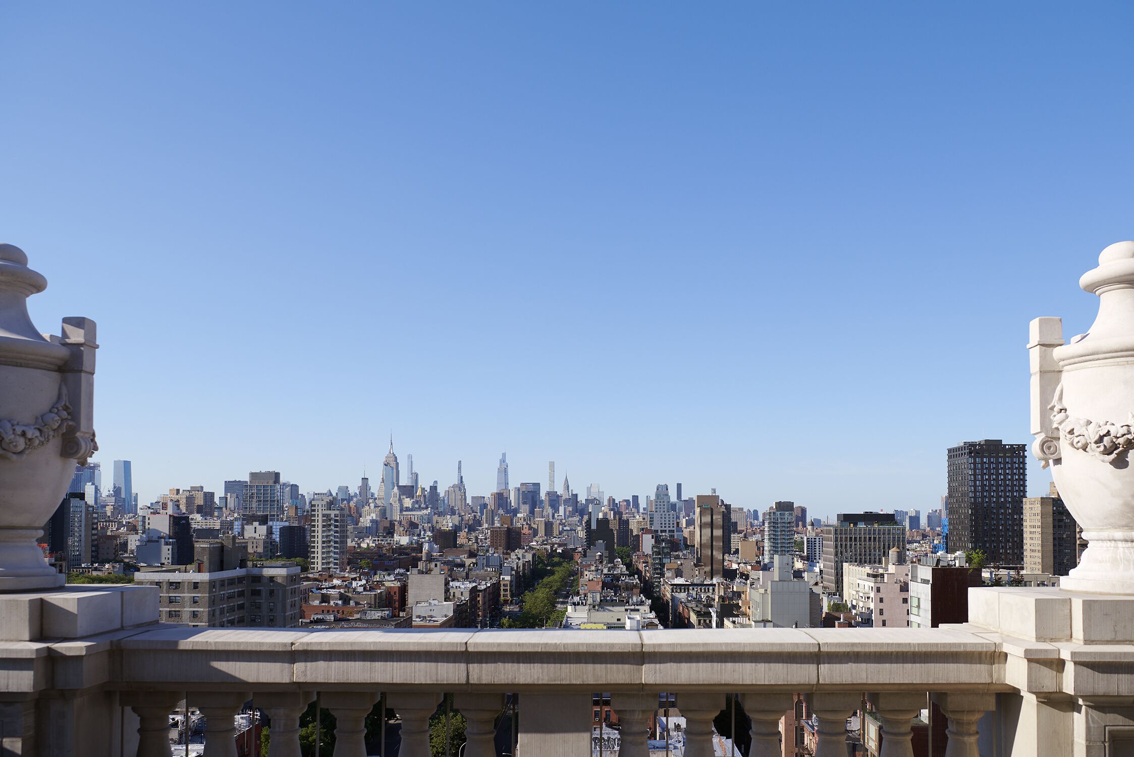 A cityscape with a view of tall buildings and a clear sky.