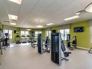 A gym with treadmills, weight machines, and exercise equipment.