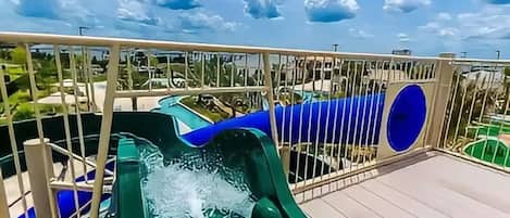 A water slide on a sunny day with a clear sky.