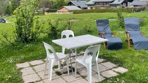 A mountain view with a patio table and chairs, surrounded by greenery and a small tree. - Studio Aux Bossons (3km From Chamonix Mont Blanc ) (Chamonix Mont-Blanc)