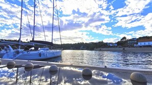 A marina with a sailboat docked, calm water, and a clear sky. - Villa Diocletian***** Solta, Premium traditional stone house next to the sea (Rogac)