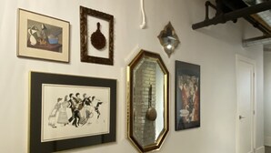 A hallway with framed artwork on the walls, a wooden floor, and a staircase leading to another level. - 1+1 heritage loft in trendy dt Toronto (Toronto)