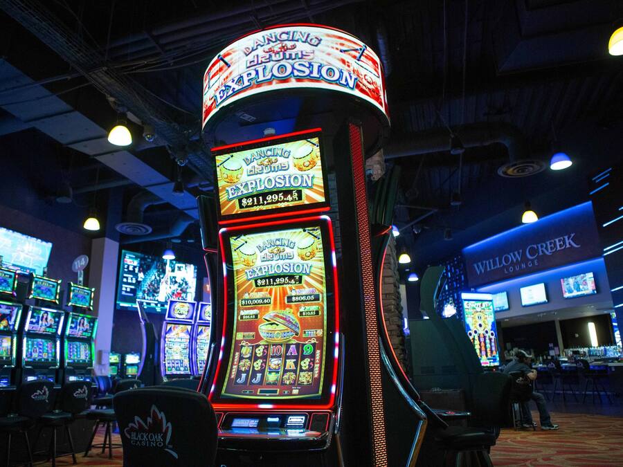 A slot machine area with multiple machines, a bar, and a lounge area.