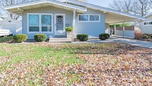 A single-story house with a front porch, a garage, and a well-maintained lawn.